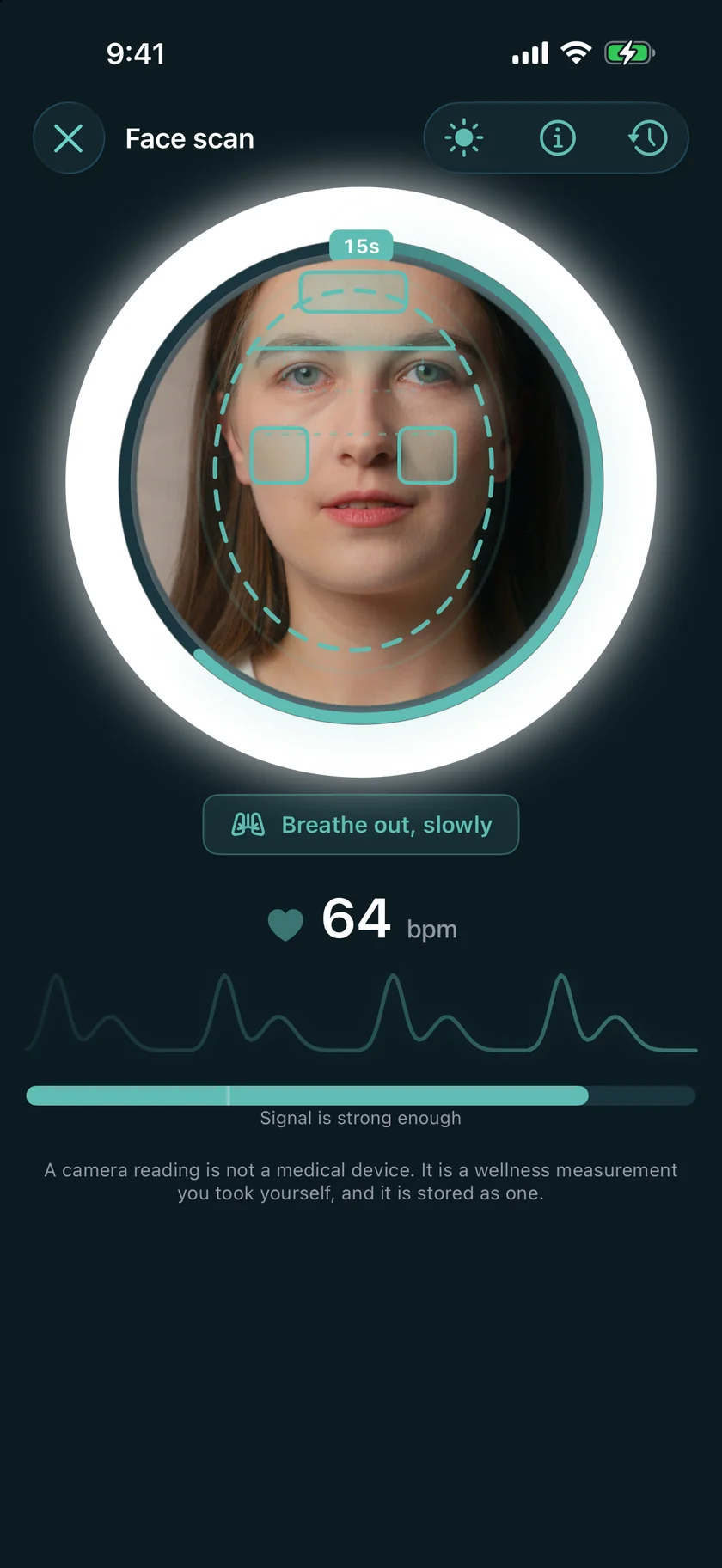 The face scan mid-read: 15 seconds left on the ring, 64 bpm, the live pulse trace and the signal bar.